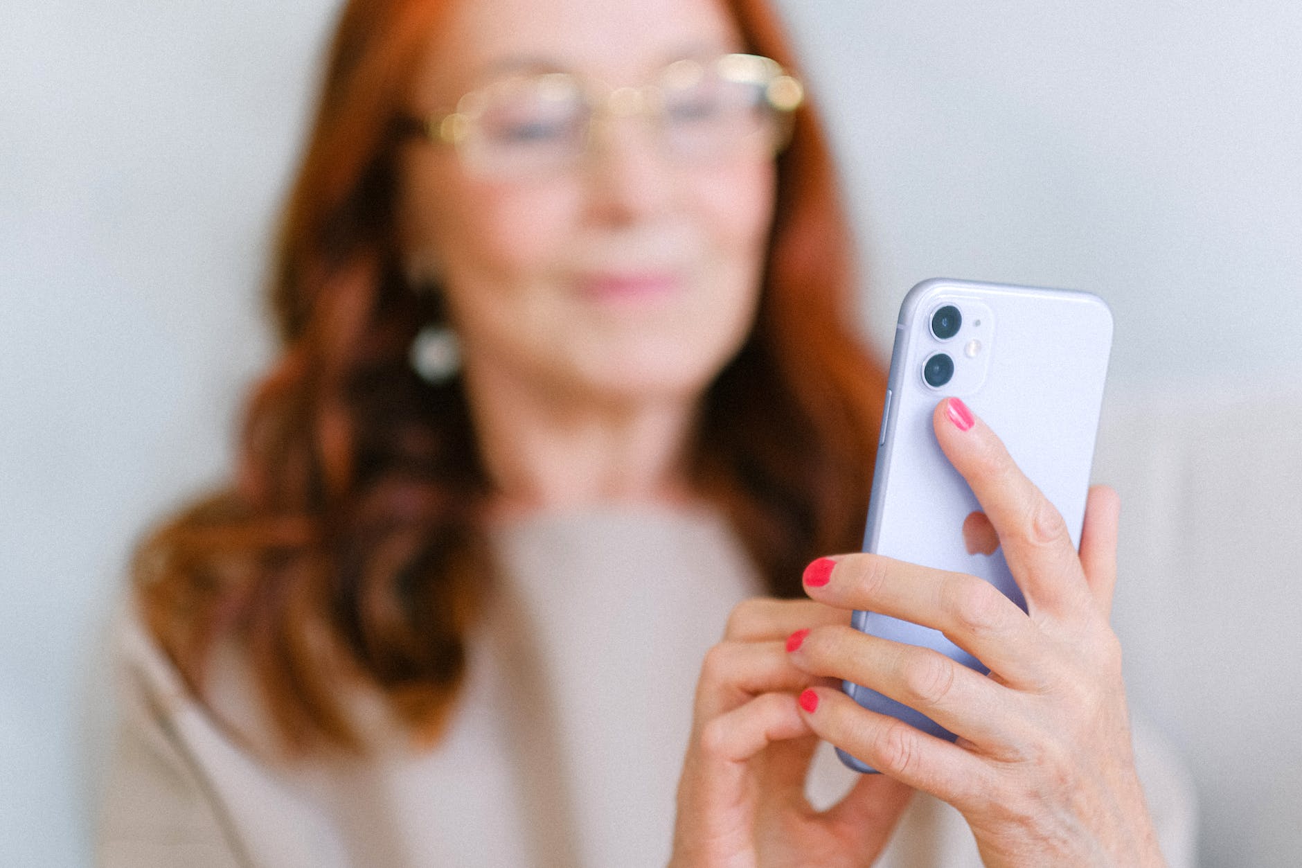 elderly woman messaging on modern smartphone